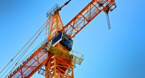 Image of an orange crane against a blue sky